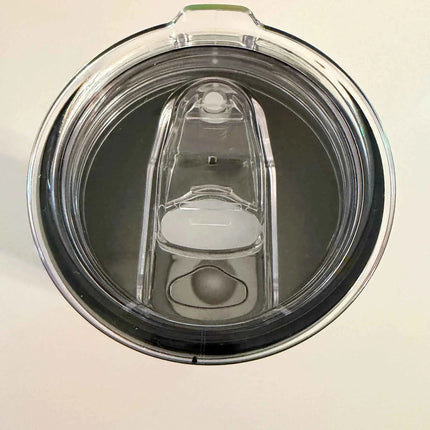 Top-down view of a clear plastic water bottle lid with a dark gray inner rim and a translucent white center spout.