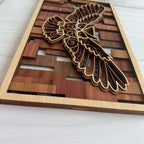 Side profile of 3D layered flying owl wood wall art showing the stacked natural hardwood construction including cherry, cedar, sapele, and walnut