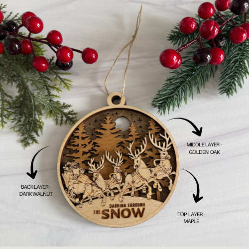 Wooden Christmas ornament with layered design and reindeer illustration, surrounded by festive elements.