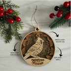 Wooden ornament with bird design and 'Forever in Our Hearts' text, surrounded by Christmas decorations.