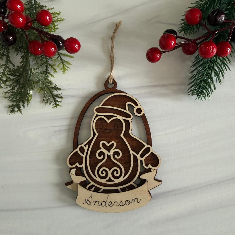 Wooden penguin ornament with personalization made with Maple and Mahogany wood by Cactus Air Designs