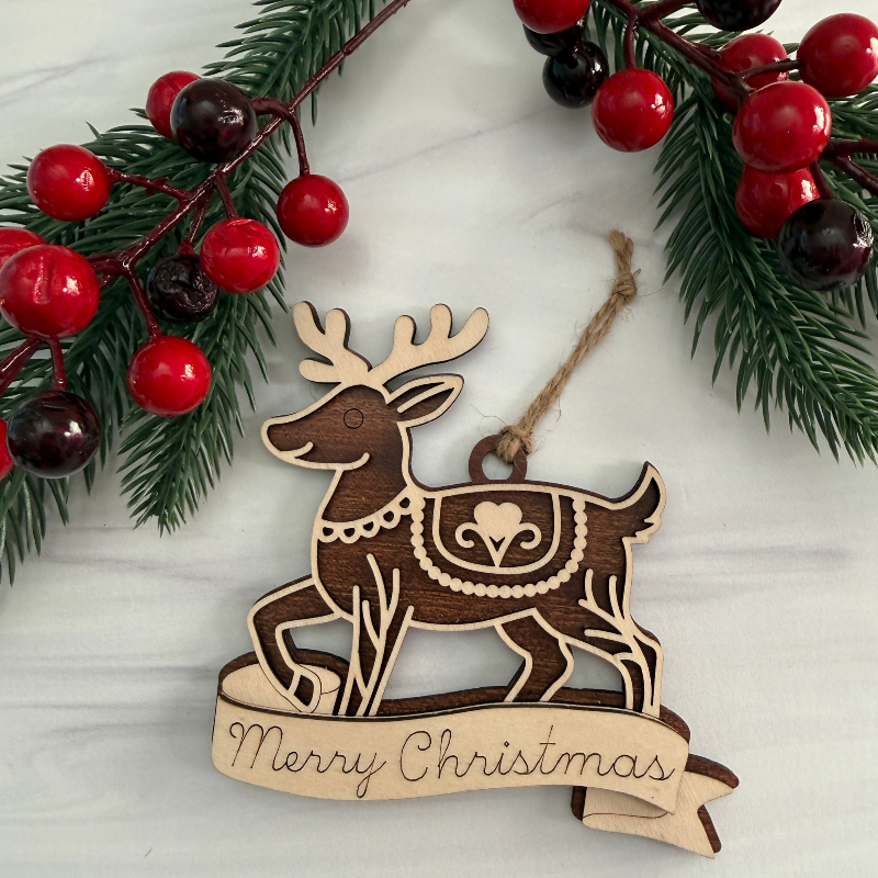Wooden reindeer ornament with banner for personalization that is made out of Maple and Mahogany wood made by Cactus Air Designs.