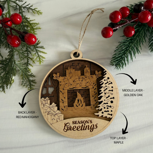 Wooden ornament with layered design featuring a fireplace and 'Season's Greetings' text, surrounded by greenery and red berries.
