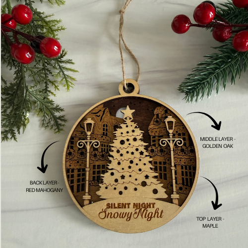 Wooden Christmas ornament with tree design and 'Silent Night Snowy Night' text, surrounded by holly and greenery.