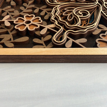 Side profile of 3D layered butterfly wood wall art showing the six-layer premium maple plywood construction and natural maple frame