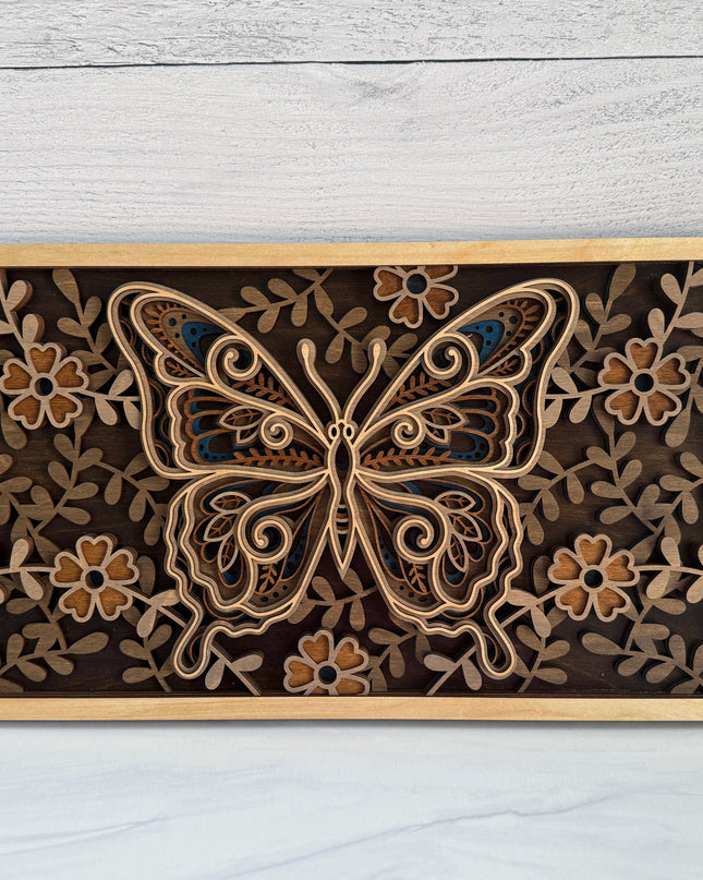 Butterfly layered wood wall art front view showing intricate mandala wing detail and full floral border in natural maple plywood with dark background