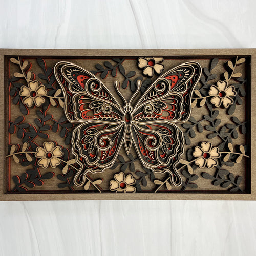 6-layer 3D laser cut wood butterfly wall art featuring intricate floral  patterns and red accents in a natural wood frame by Cactus Air Designs.