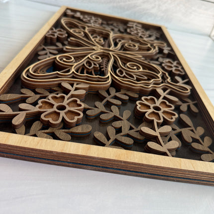 Short side close-up of butterfly layered wood wall art showing layered floral border construction and real wood layer depth