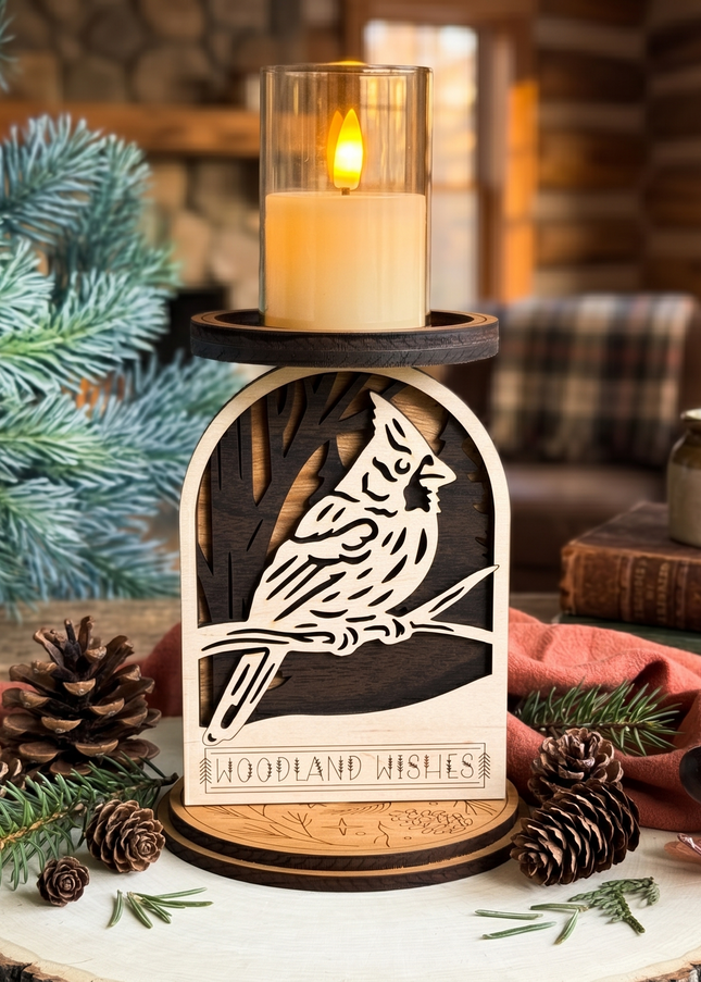 Wooden candle holder with cardinal design on a rustic setting with a LED candle on the candle holder and pinecones by Cactus Air Designs. 