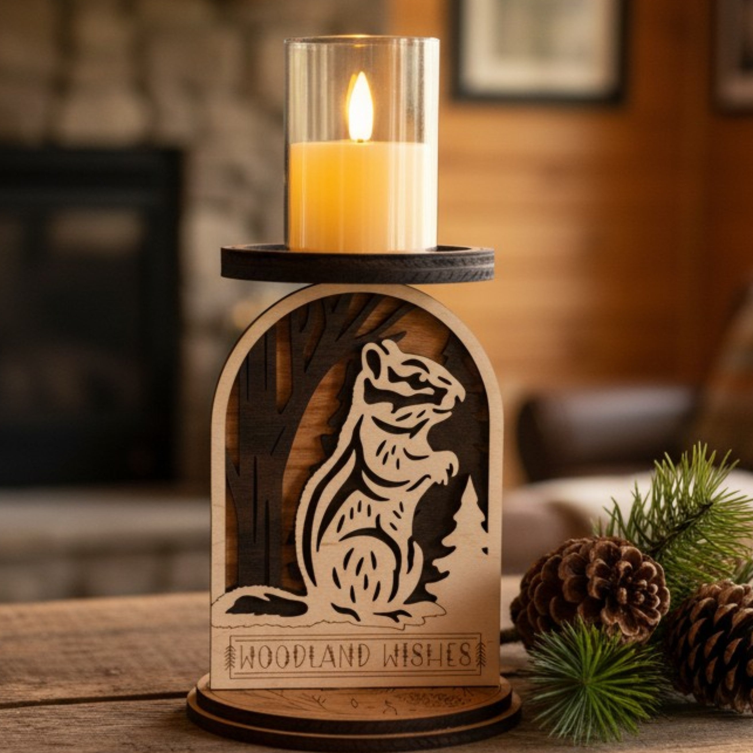 Candle holder with a squirrel design and 'Woodland Wishes' text, featuring a lit LED candle by Cactus Air Designs.