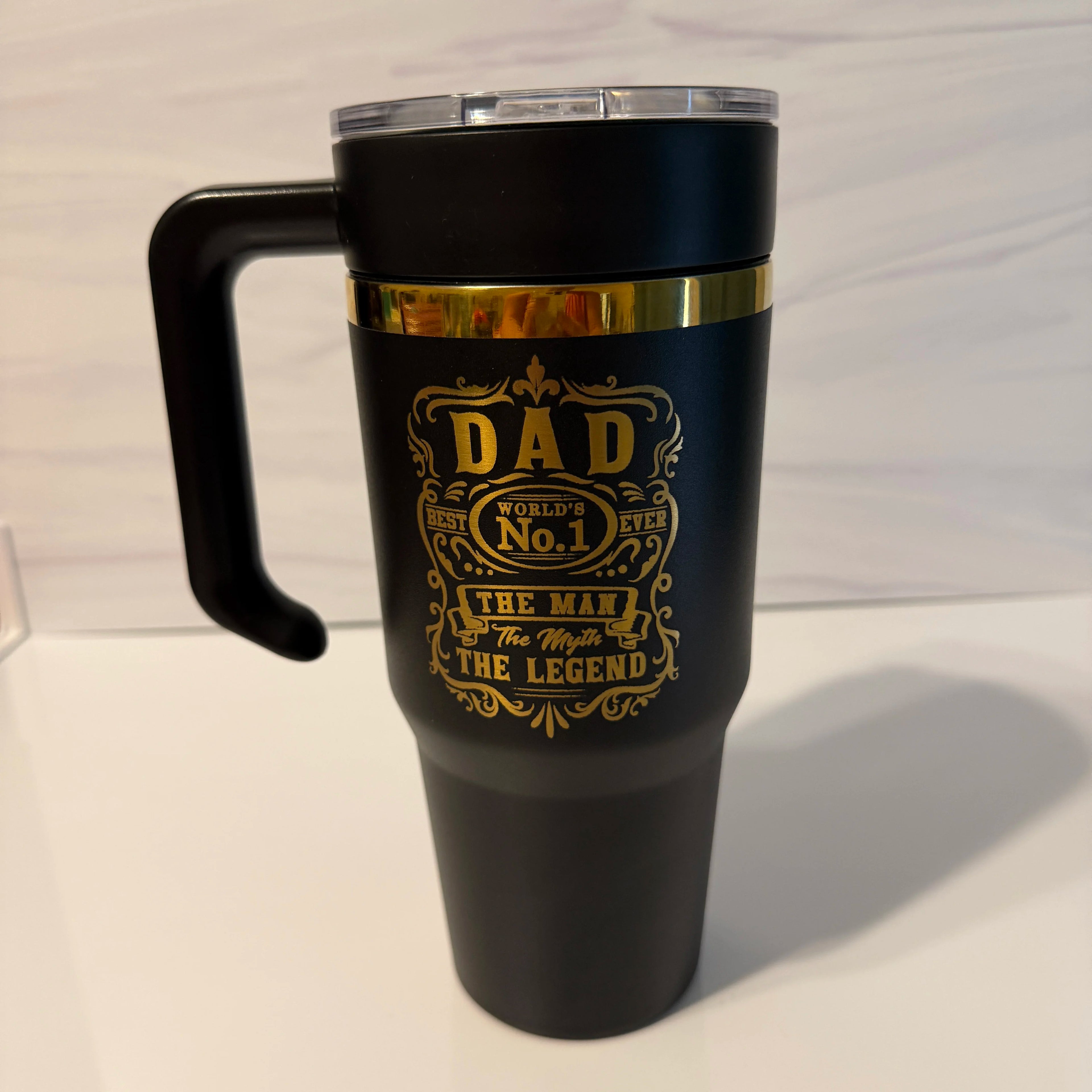 Full shot of black and gold electroplated 30oz tumbler with handle lid featuring the Dad: The Man, The Myth, The Legend design, made in Arizona