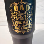 Closeup of laser-engraved Dad: The Man, The Myth, The Legend design in gold on a black electroplated tumbler by Cactus Air Designs