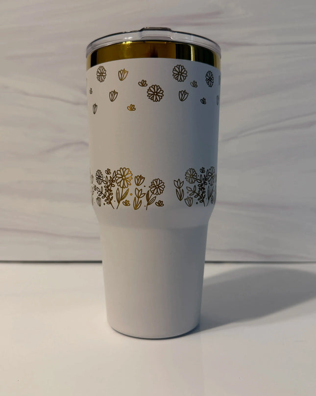 Alt text: Back view of white and gold electroplated laser-engraved tumbler showing full floral meadow wrap design by Cactus Air Designs