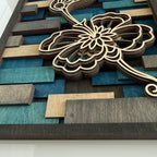 Cactus Air Designs layered wood wall art featuring a geometric hummingbird and floral design in blue and natural wood tones.