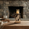 Candle holder with owl design in front of a stone fireplace by Cactus Air Desgins