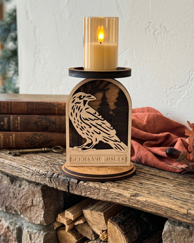Laser-cut raven woodland candle holder displayed on rustic wood mantel with LED candle glowing, cozy cabin decor by Cactus Air Designs