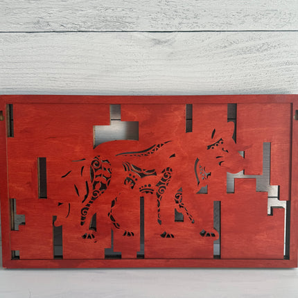 Layered wolf wood art with a solid red-stained backing that highlights the intricate laser-cut geometric patterns and shadows.