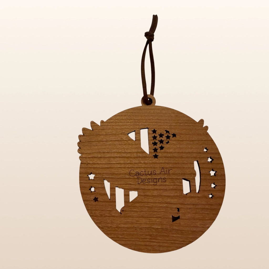 Back of USA 250th Anniversary Bald Eagle ornament showing Cactus Air Designs maker's mark on Premium Cherry plywood with leather cord hanger