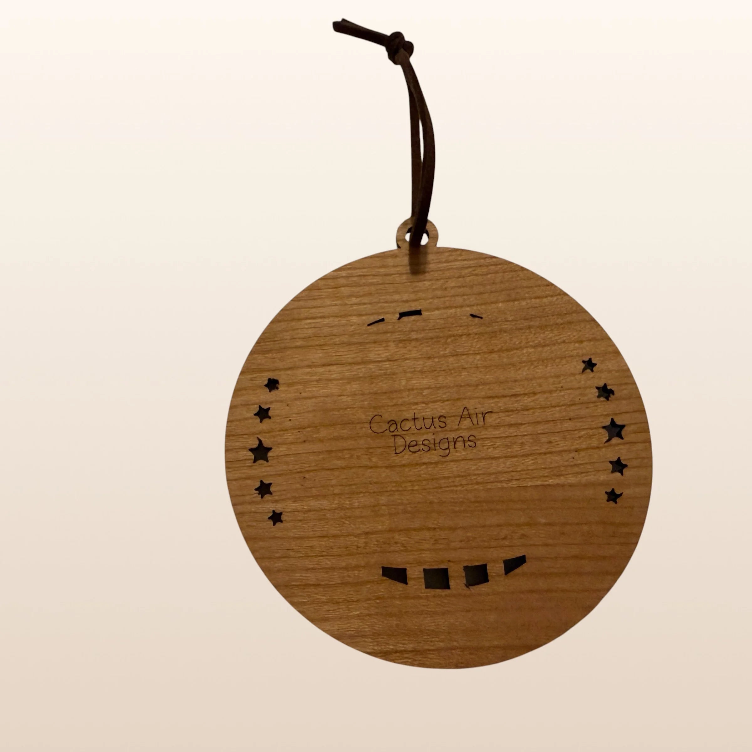 Back of USA 250th Anniversary Cheeseburger ornament showing Cactus Air Designs maker's mark on Premium Cherry plywood with leather cord hanger