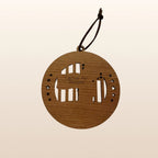 Back of USA 250th Anniversary Moon Landing ornament showing Cactus Air Designs maker's mark on Premium Cherry plywood with leather cord hanger
