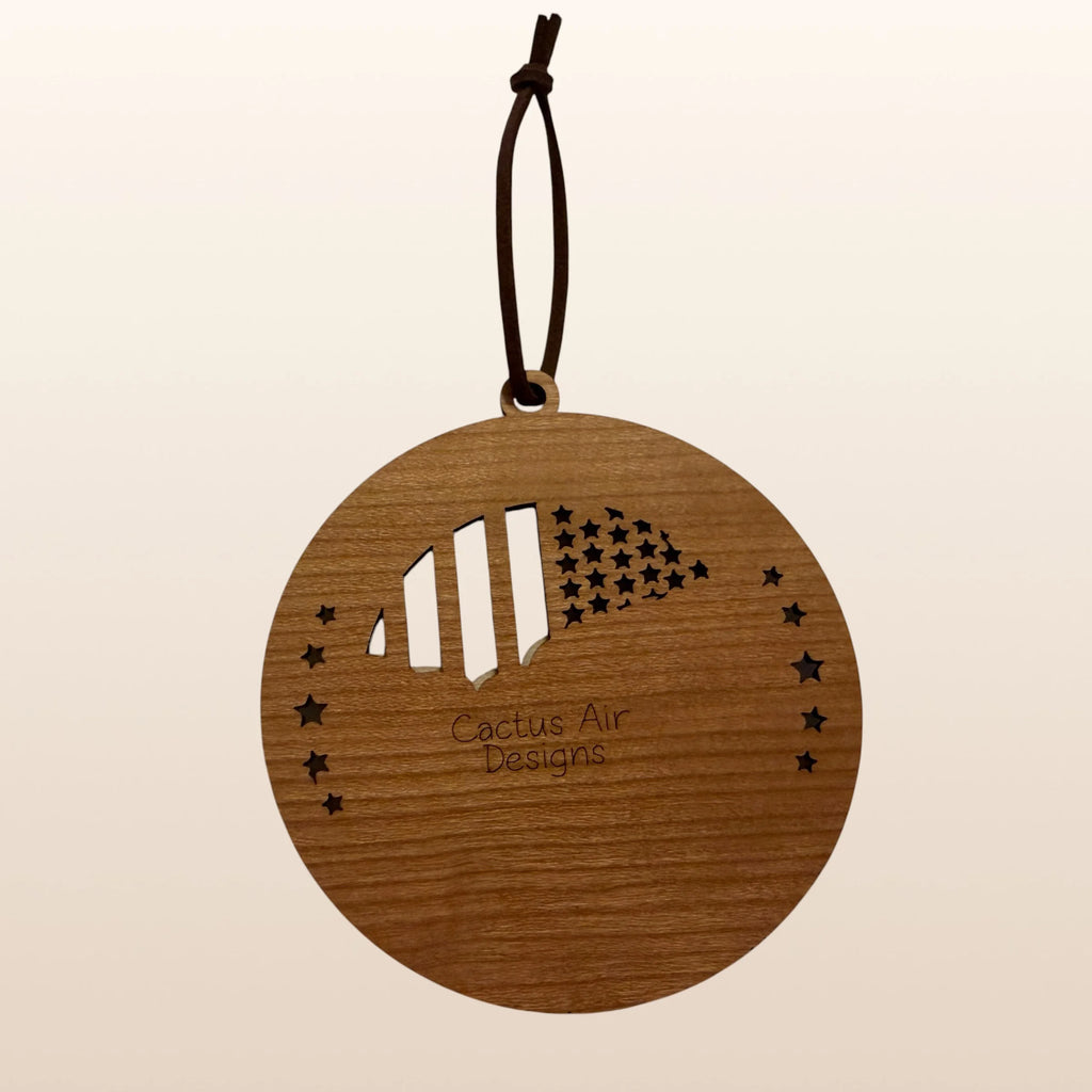 Back of USA 250th Anniversary Mount Rushmore ornament showing Cactus Air Designs maker's mark on Premium Cherry plywood with leather cord hanger