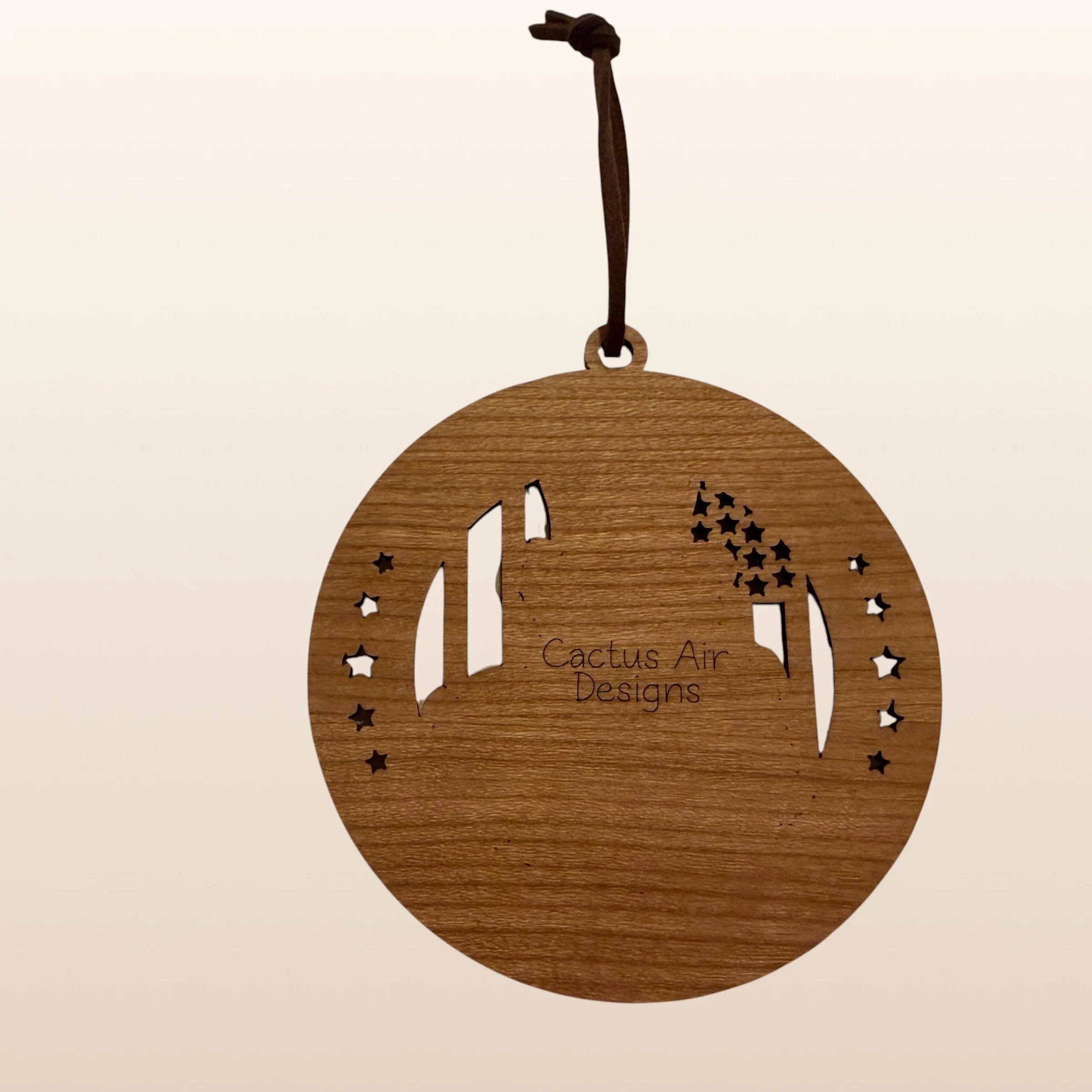 Back of USA 250th Anniversary Uncle Sam ornament showing Cactus Air Designs maker's mark on Premium Cherry plywood with leather cord hanger