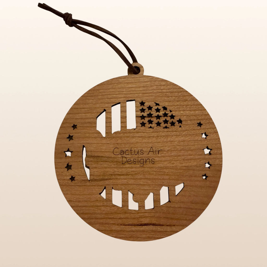 Back of USA 250th Anniversary USA Map ornament showing Cactus Air Designs maker's mark on Premium Cherry plywood with leather cord hanger
