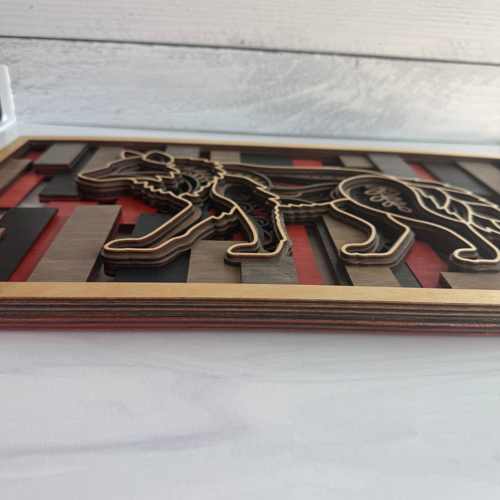 Long side view of 3D wolf wall art showing the depth of five individual wood layers and the textured 'mandala' style engravings on the wolf silhouette