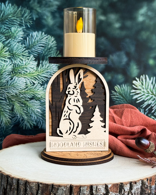 Wooden candle holder with rabbit design on a tree stump against a forest background