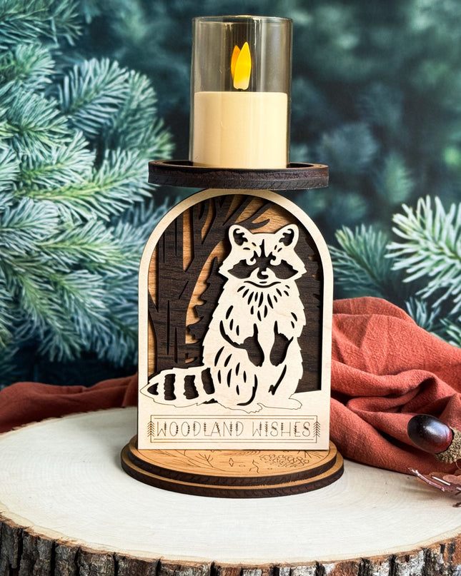 Candle holder with raccoon design on a wooden base against a forest background