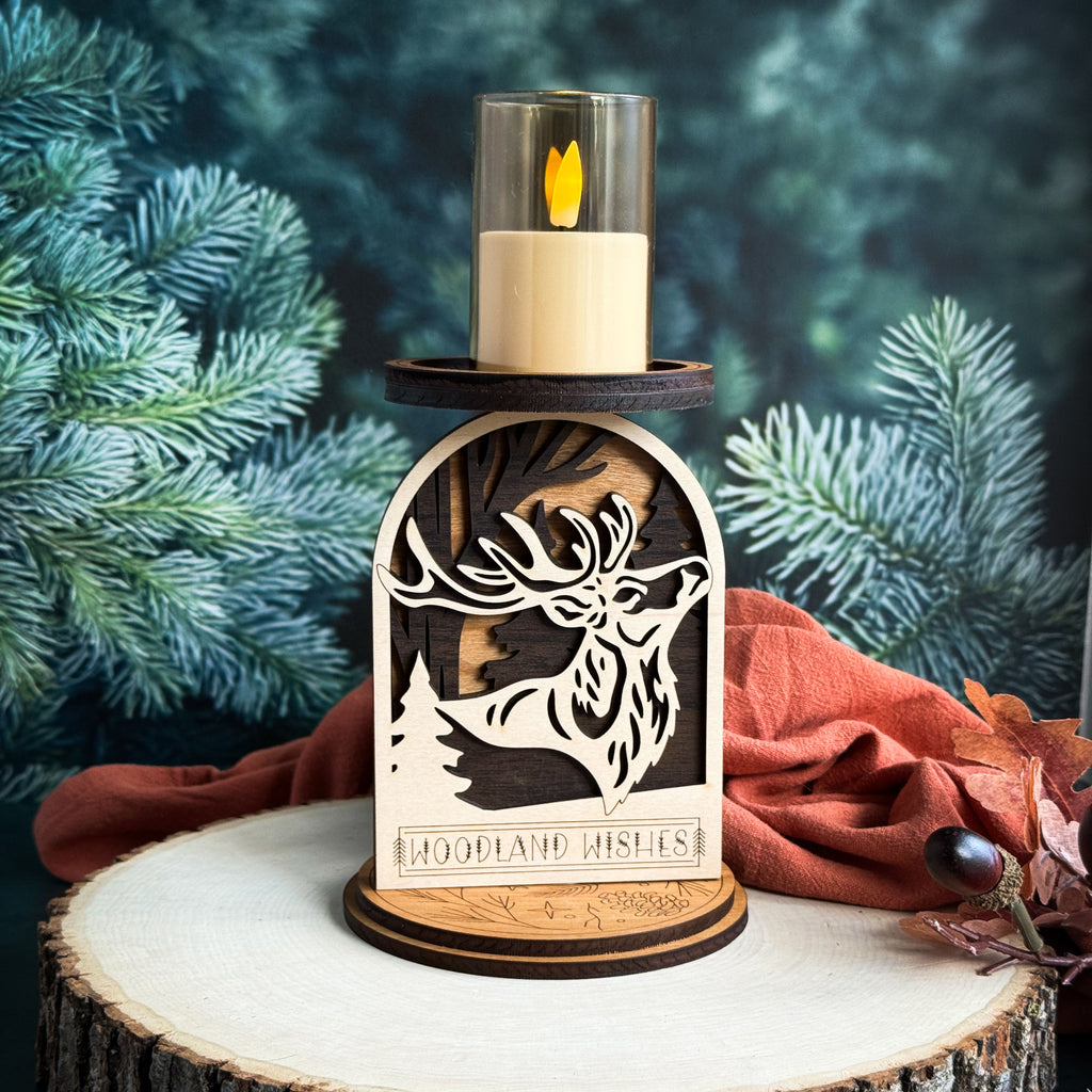 Wooden candle holder with deer design against a forest background