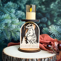 Wooden candle holder with weasel design and 'Woodland Wishes' text, against a green foliage background.