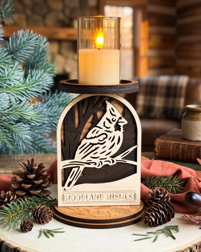 Layered wood woodland cardinal candle holder with LED candle lit, displayed on a wood slice with pine cones and pine branches in cabin setting