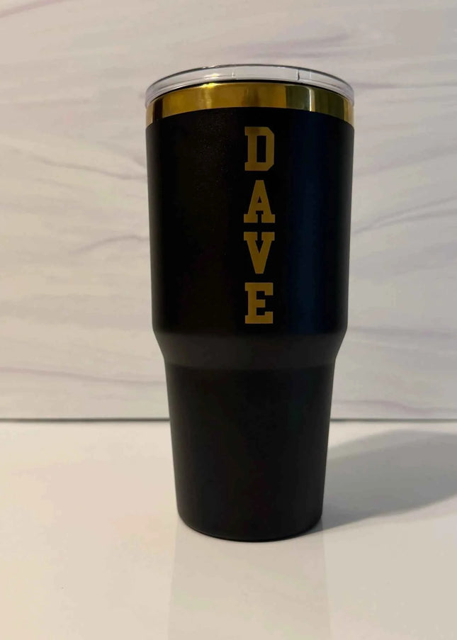 30 oz black powder coated electroplated tumbler with gold laser engraved with Dave on the back as the example of personalization.
