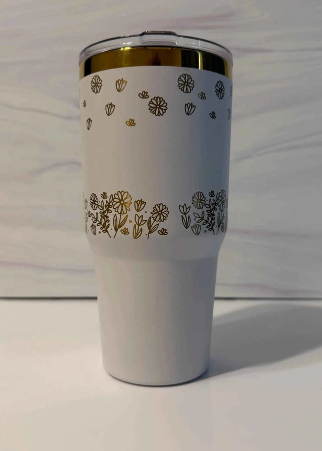Back view of white gold electroplated tumbler showing laser engraved wildflower meadow design wrapping around the full tumbler
