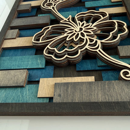 Top-down close-up of flower cutwork on layered wood wall art showing laser-cut detail and stain depth on premium maple plywood