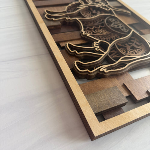 Close-up angled view of 3D Highland Cow art showing the physical depth of the 5 layers and the detailed floral-style engravings on the cow's silhouette.