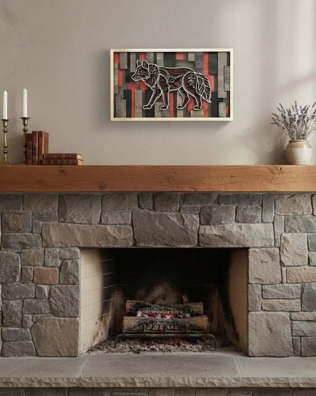 A framed abstract artwork featuring a stylized wolf in black, white, and red tones, displayed on a beige wall above a stone fireplace with a wooden mantel and decorative candles.