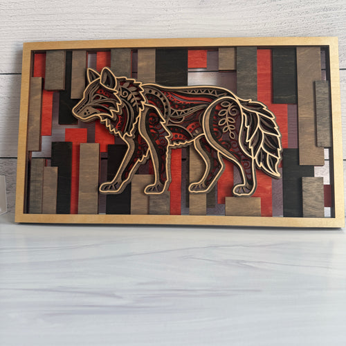 Front view of a 3D layered wolf wood wall art featuring five intricate laser-cut layers against a geometric red, black, and grey stained bar background