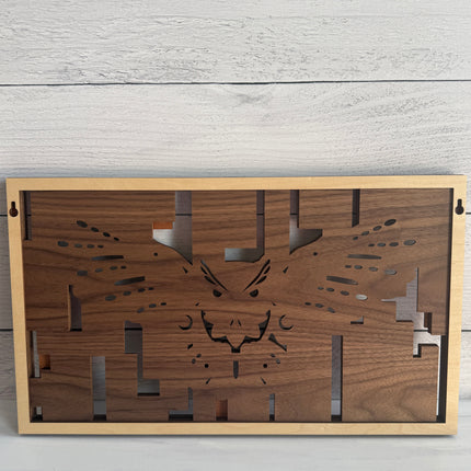 Back of layered flying owl wood wall art showing built-in wall hanger and natural wood backing