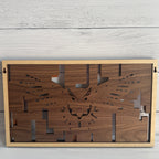 Back of layered flying owl wood wall art showing built-in wall hanger and natural wood backing