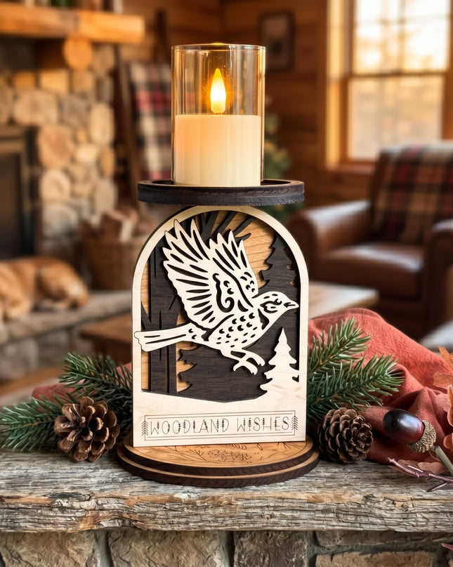Layered wood woodland sparrow in flight candle holder with LED candle lit, displayed on a wood slice with pine branches in background
