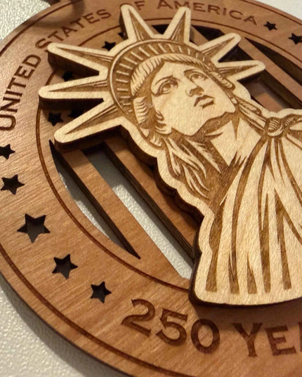 Close up detail of laser cut Statue of Liberty on USA 250 Years of Freedom wood ornament showing maple and cherry layers