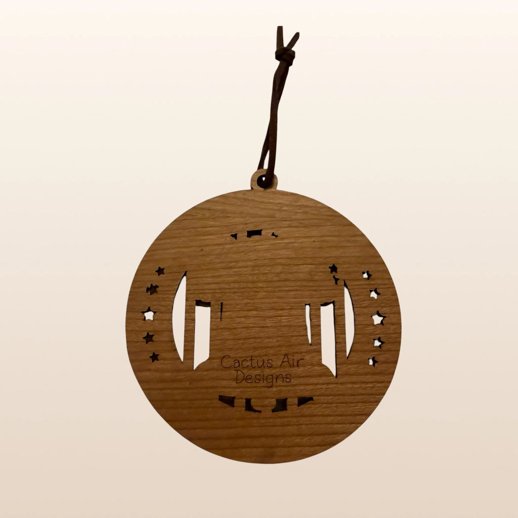 Back of USA 250th Anniversary Liberty Bell ornament showing Cactus Air Designs maker's mark on Premium Cherry plywood with leather cord hanger