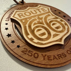 Close up detail of laser engraving on USA 250th Anniversary Route 66 wood ornament showing Premium Cherry plywood and Maple plywood layers