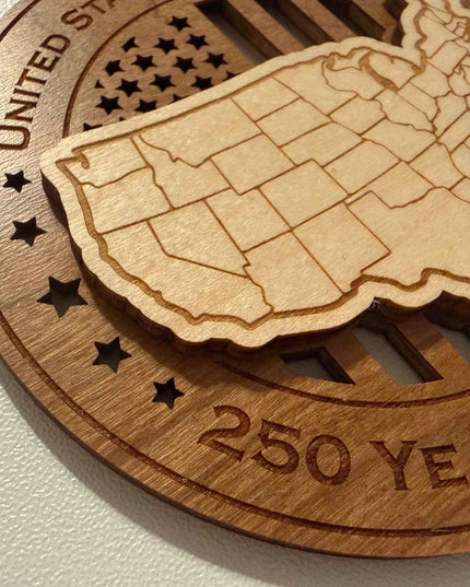 Close up detail of laser cut USA Map on USA 250 Years of Freedom wood ornament showing maple and cherry layers

