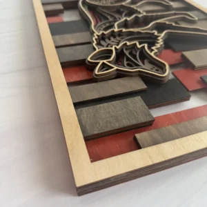Angled close-up of wolf layered wall art showing stacked maple layers and bold red and black stained mosaic background