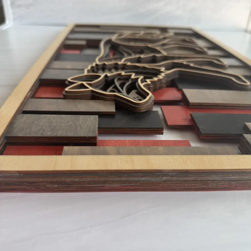 Short side view of wolf layered wall art showing full layer stack depth and stained slat background