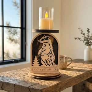 Front view of layered wooden badger candle holder showing size scale on wooden tabletop near a window.