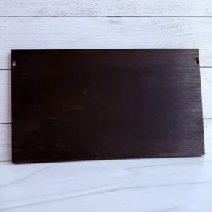 Rear view of the dark wood backing showing the built-in side hanging notches for wall mounting.